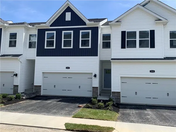 a large kitchen with kitchen island a stove a refrigerator a sink dishwasher and a oven with wooden floor