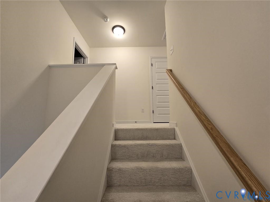 7825 Old Guild Road Richmond, VA 23237 - Photo 14 of 27 Carpeted staircase with a wood-finish handrail and