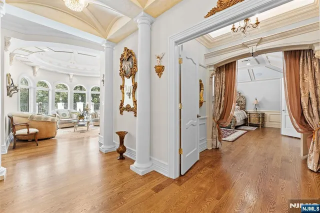 a view of a livingroom with furniture a ceiling fan and front door