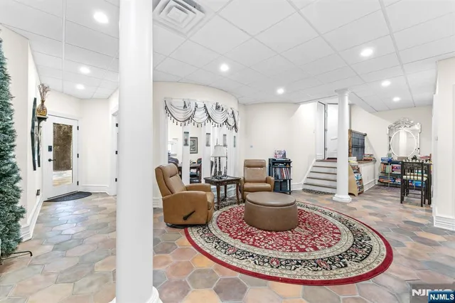 a living room with furniture and a dining table