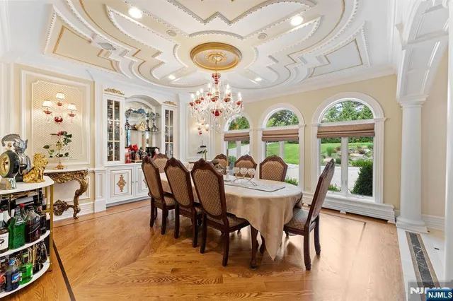 a view of a dining room with furniture large windows and wooden floor