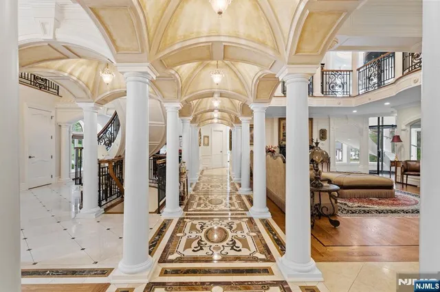 a view of a hallway with a dining table and chandelier