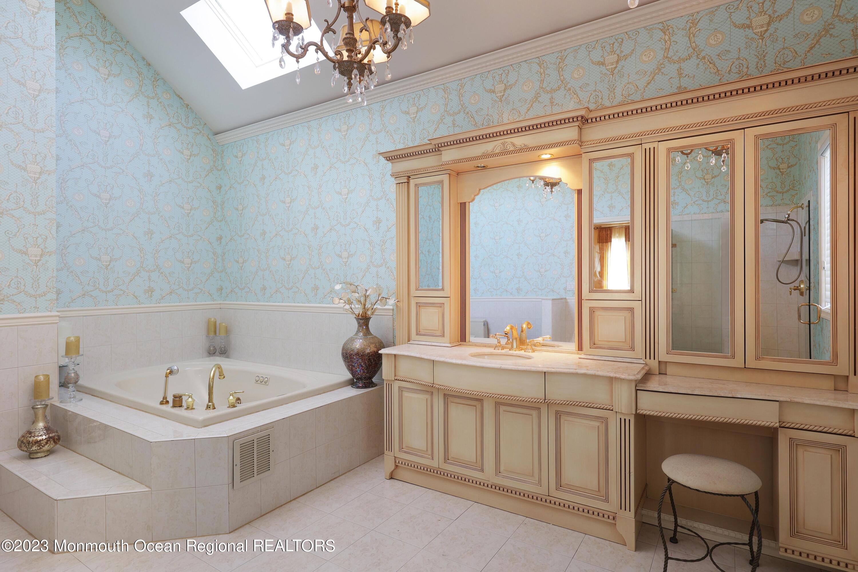 8 Old Stable Way Colts Neck, NJ 07722 - Photo 22 of 45 a bathroom with a tub a sink and a large mirror