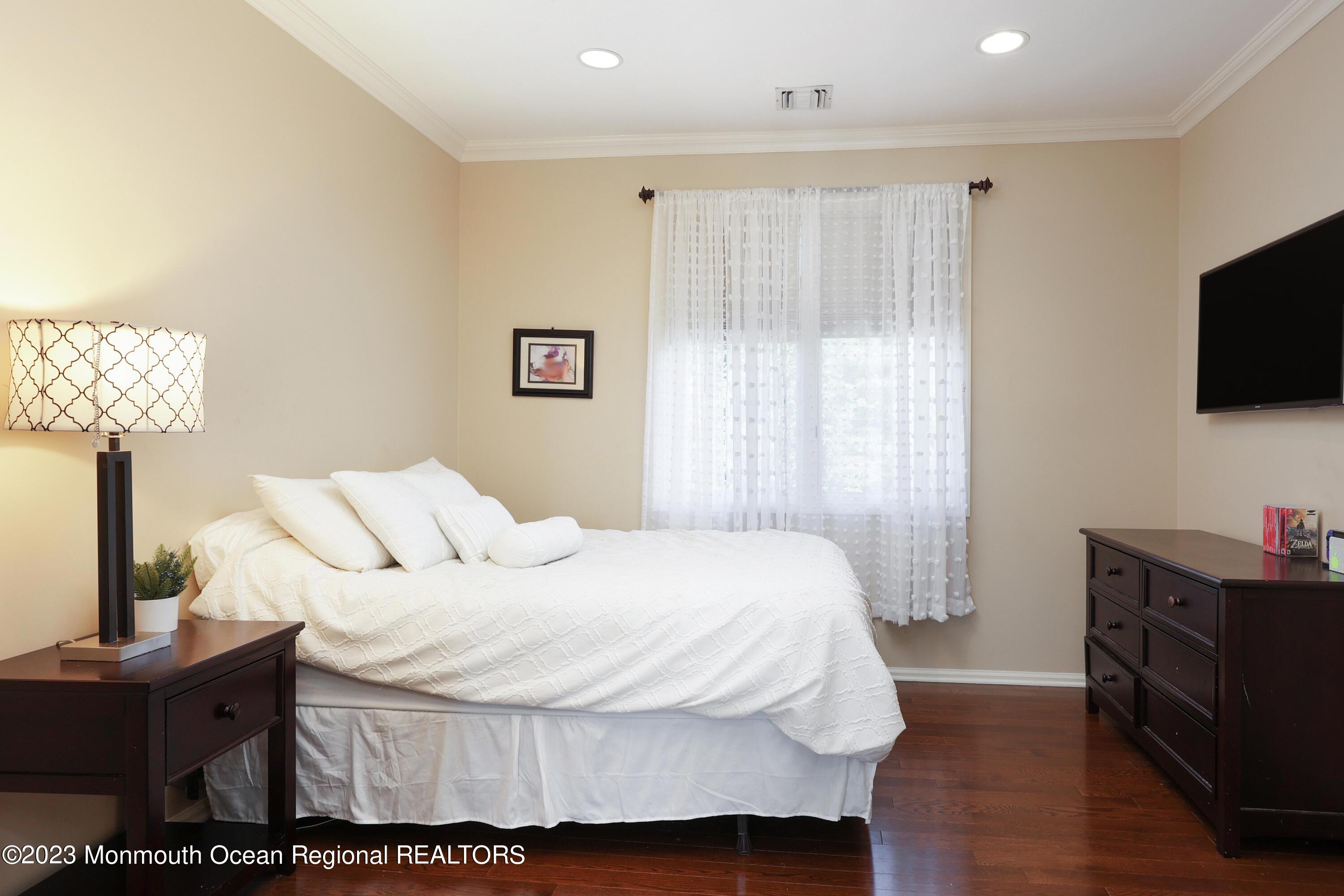 8 Old Stable Way Colts Neck, NJ 07722 - Photo 23 of 45 a bedroom with a bed and flat screen tv