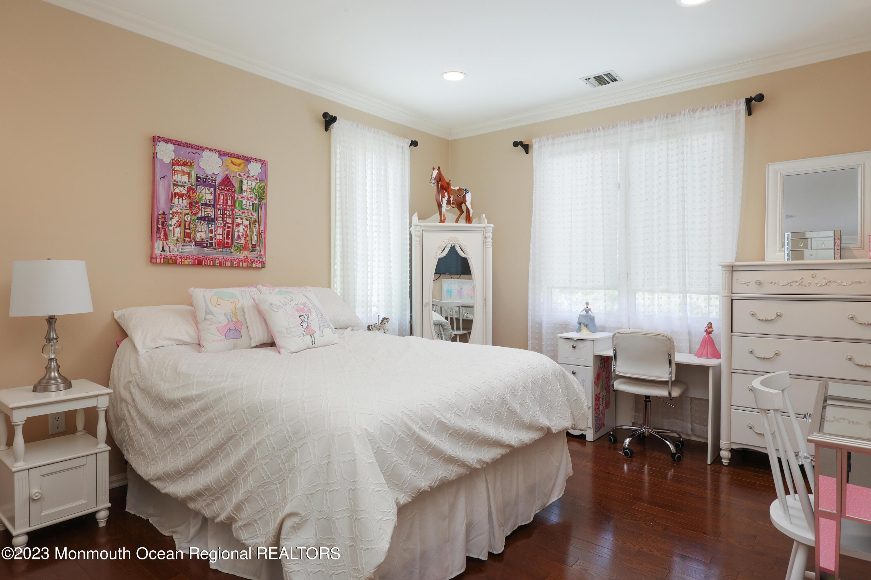 8 Old Stable Way Colts Neck, NJ 07722 - Photo 25 of 45 a bedroom with a bed and a chandelier
