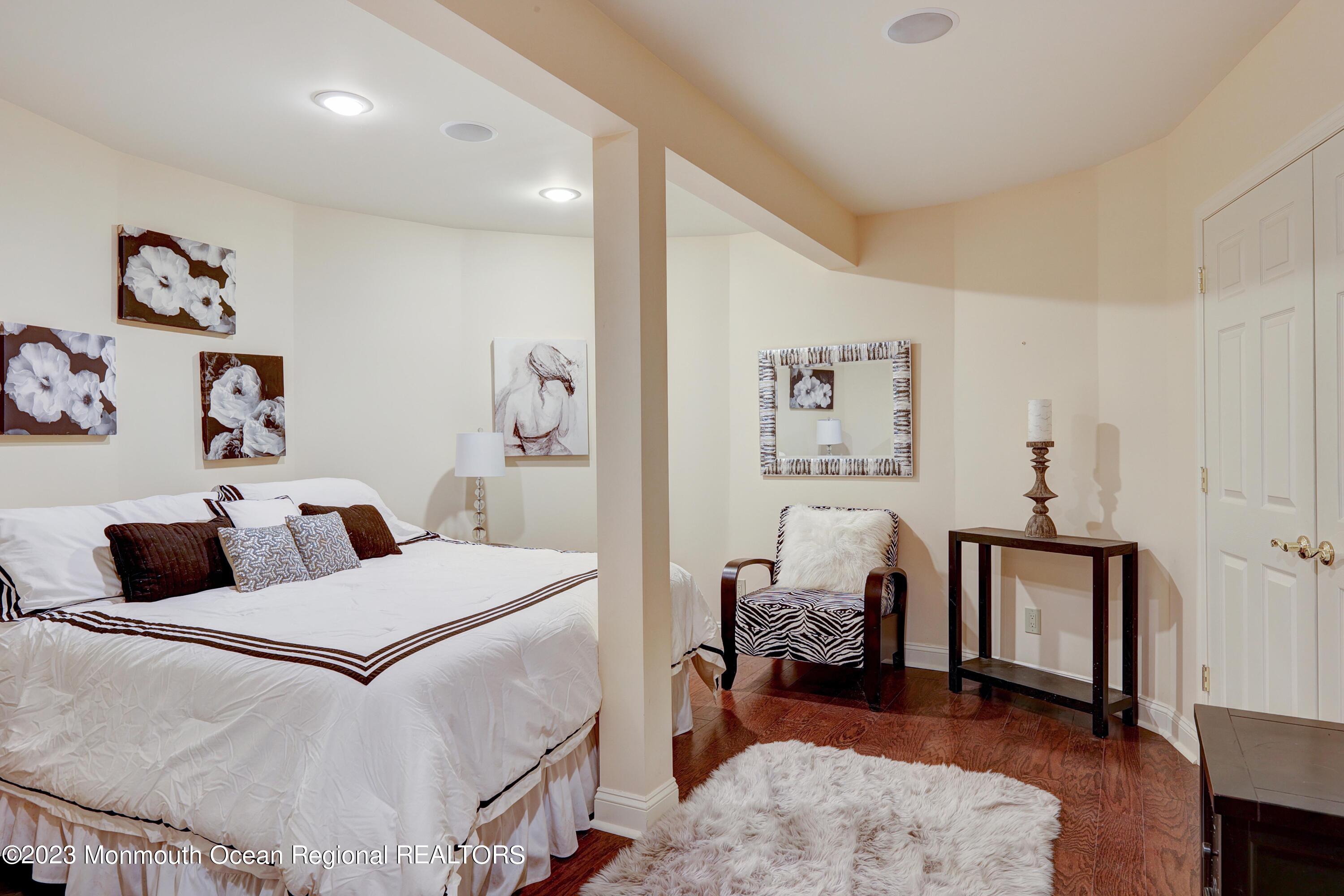 8 Old Stable Way Colts Neck, NJ 07722 - Photo 26 of 45 a bedroom with a bed and wooden floor
