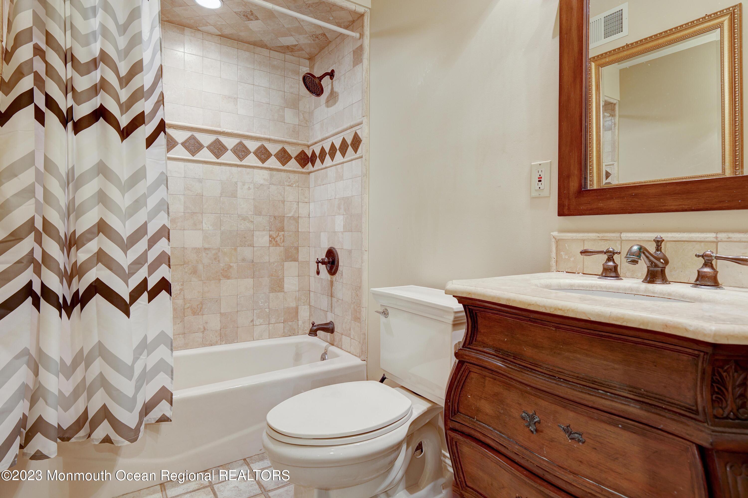 8 Old Stable Way Colts Neck, NJ 07722 - Photo 28 of 45 a bathroom with a granite countertop sink mirror vanity and toilet