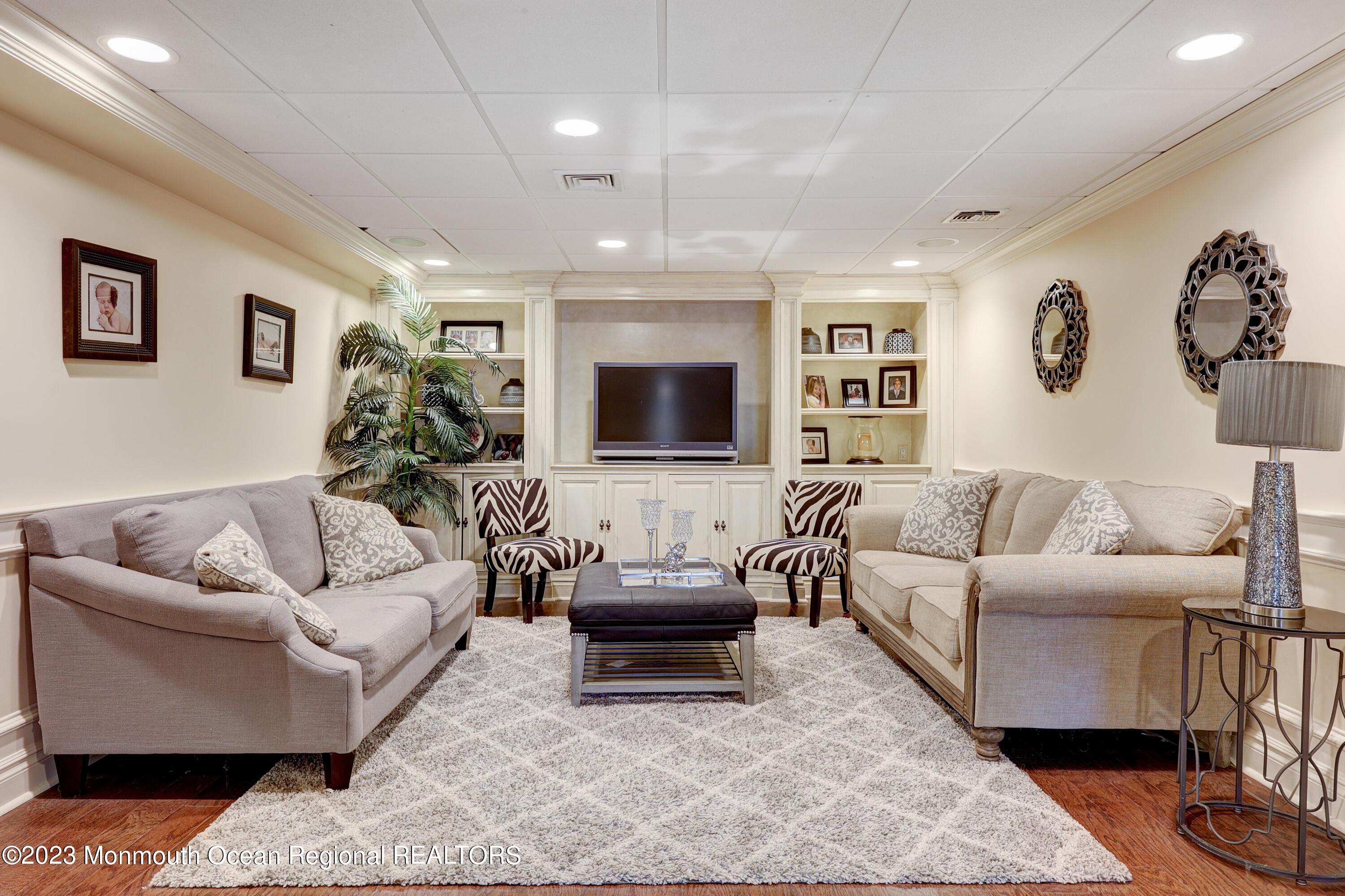 8 Old Stable Way Colts Neck, NJ 07722 - Photo 29 of 45 a living room with furniture and a flat screen tv