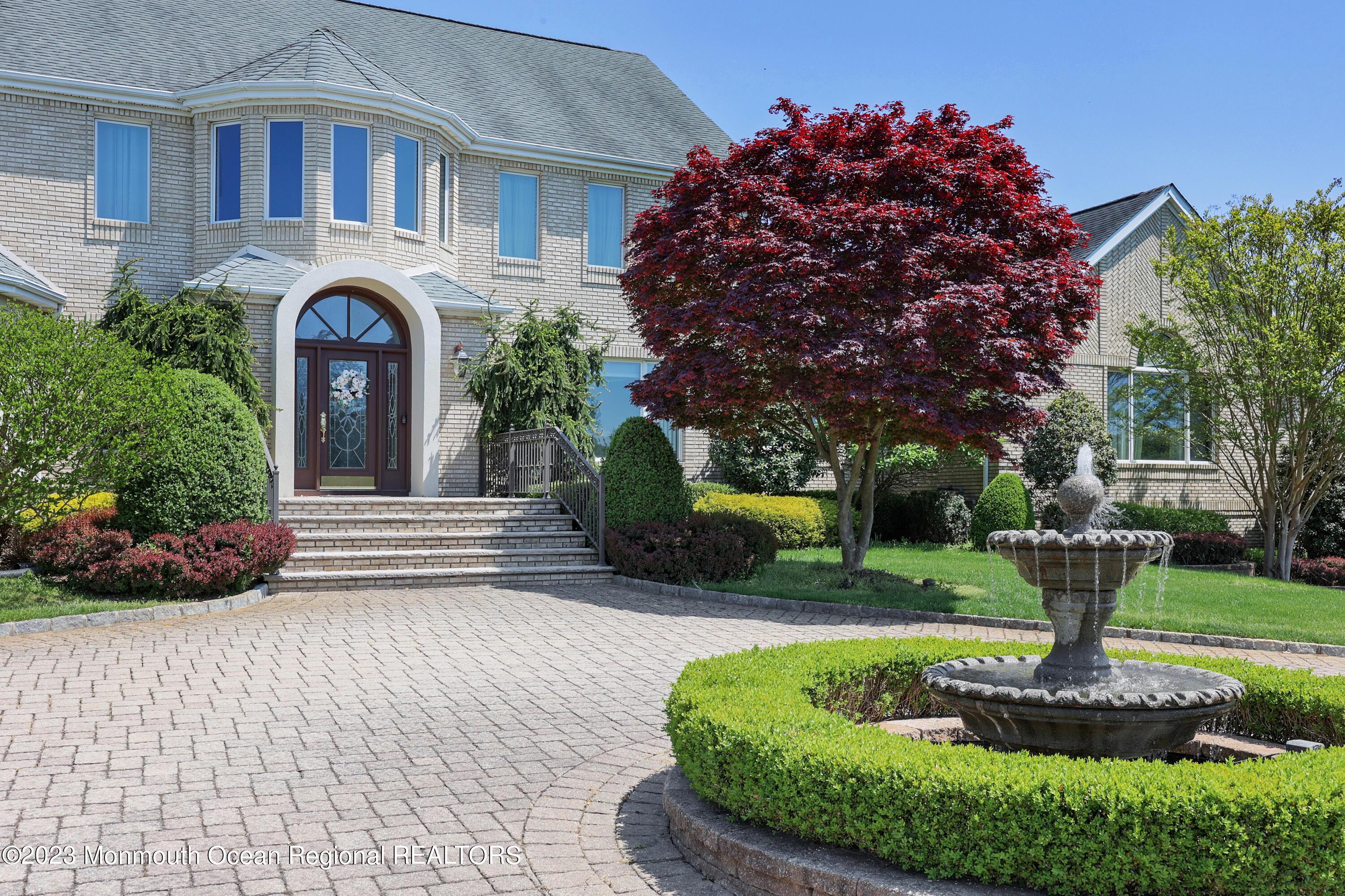 8 Old Stable Way Colts Neck, NJ 07722 - Photo 3 of 45 a front view of a house with a garden