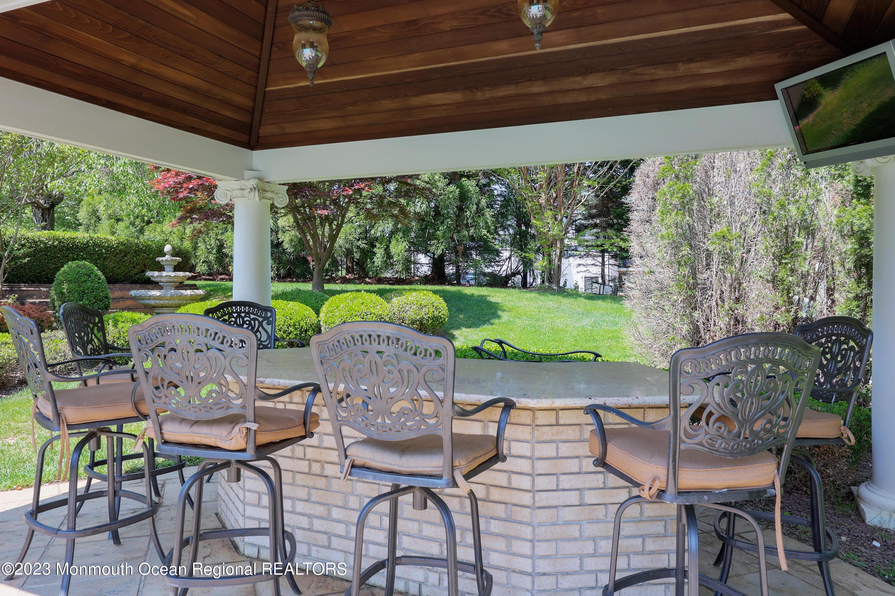 8 Old Stable Way Colts Neck, NJ 07722 - Photo 39 of 45 a view of an outdoor dining space with furniture and garden view