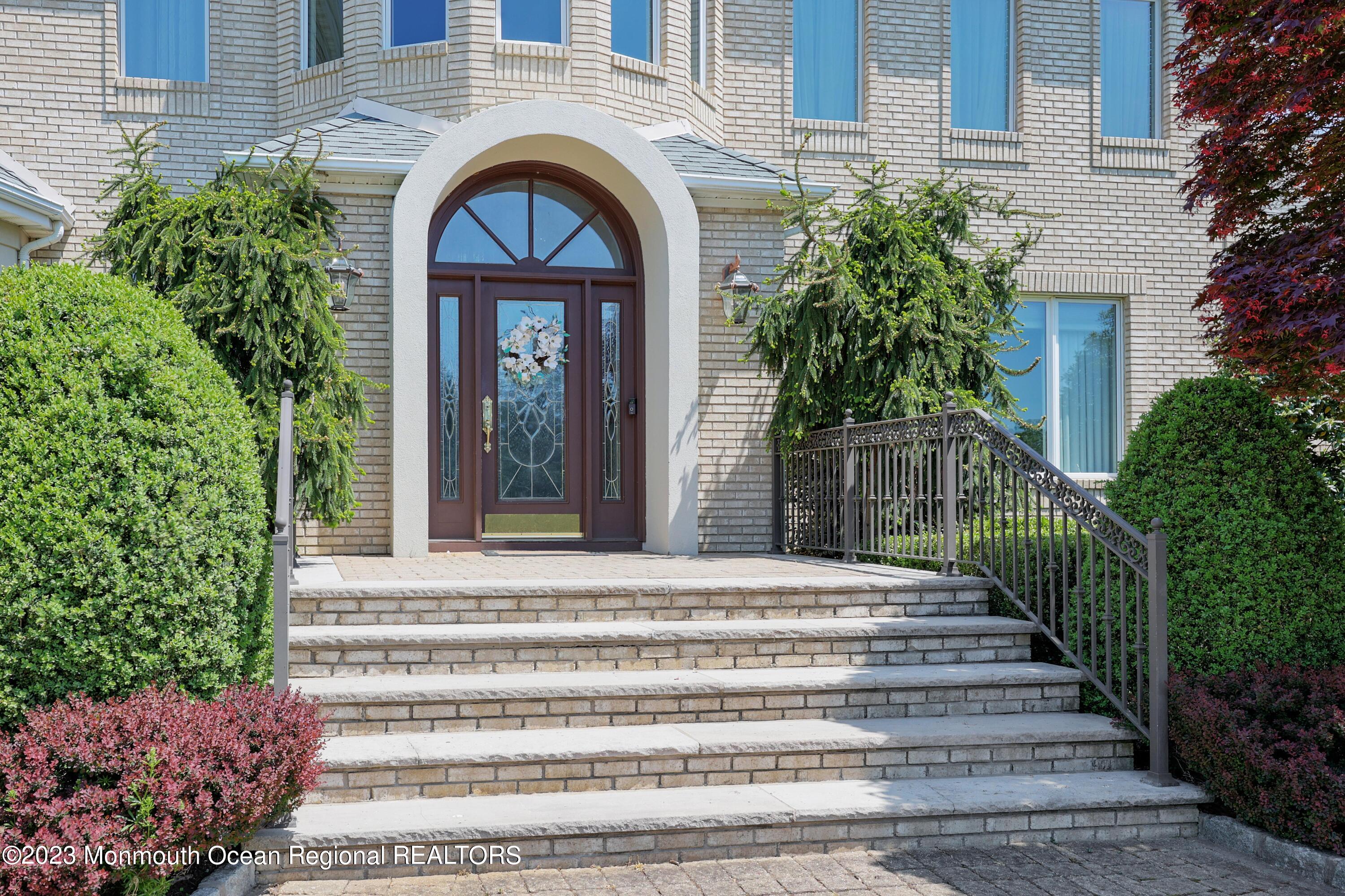 8 Old Stable Way Colts Neck, NJ 07722 - Photo 4 of 45 a front view of a house with a garden