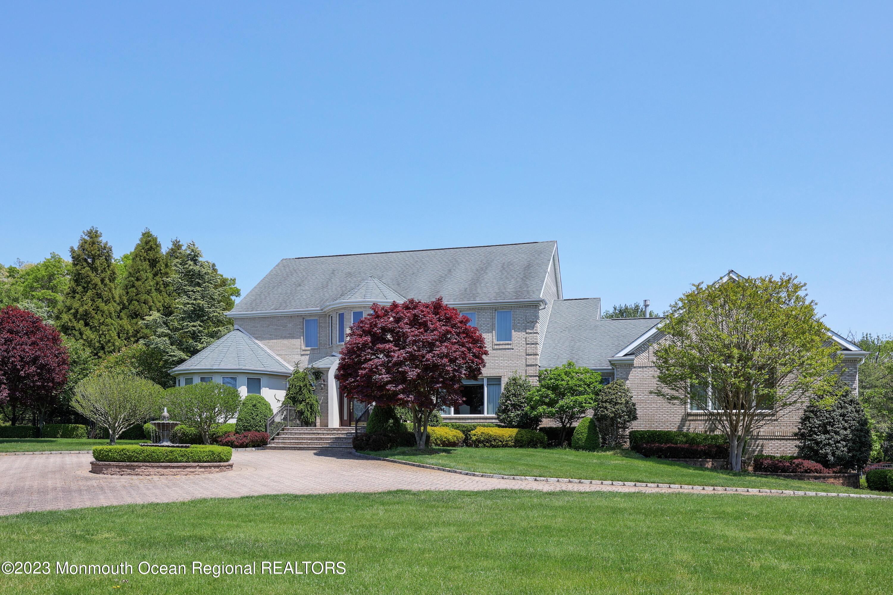 8 Old Stable Way Colts Neck, NJ 07722 - Photo 44 of 45 a front view of a house with a yard and outdoor seating