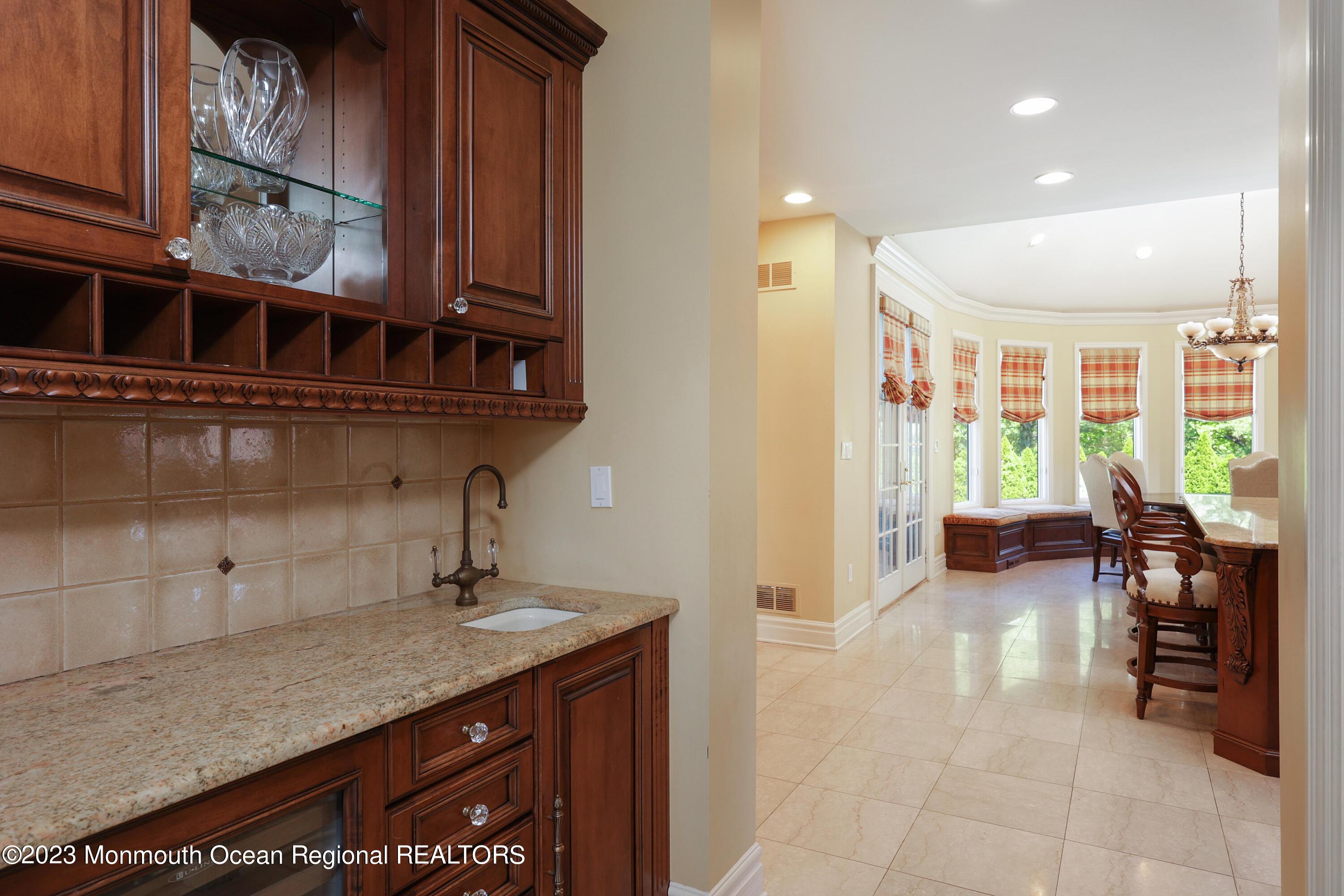 8 Old Stable Way Colts Neck, NJ 07722 - Photo 9 of 45 a hallway with a sink and a mirror