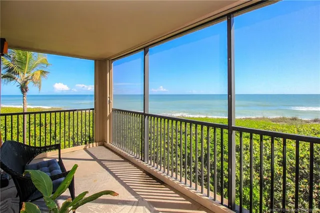 a view of balcony with floor to ceiling windows with wooden floor
