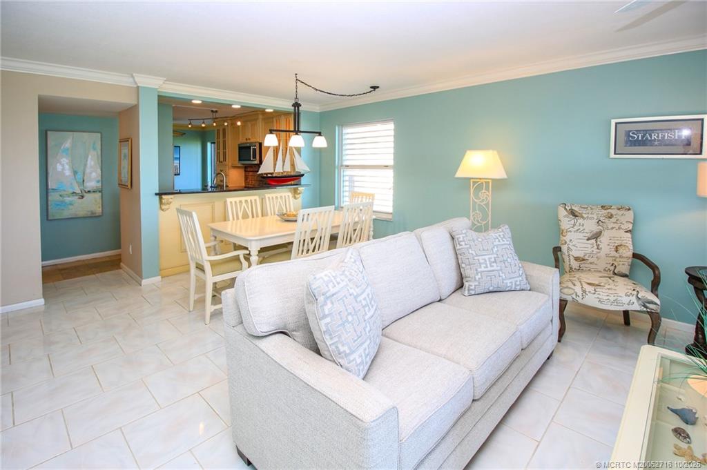 2571 Northeast Ocean Boulevard, Unit 10203 Stuart, FL 34996 - Photo 14 of 46 a living room with a couch and a chandelier