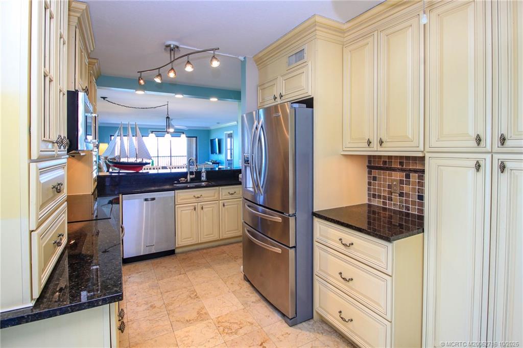 2571 Northeast Ocean Boulevard, Unit 10203 Stuart, FL 34996 - Photo 20 of 46 a kitchen with stainless steel appliances a refrigerator sink and cabinets