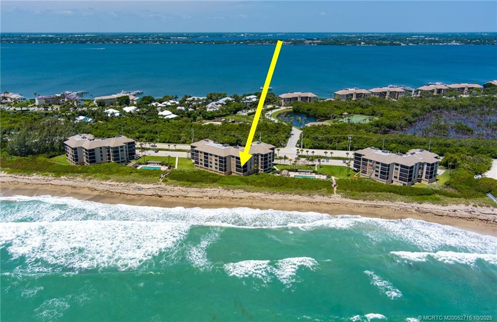 2571 Northeast Ocean Boulevard, Unit 10203 Stuart, FL 34996 - Photo 2 of 46 a view of a house with a yard and lake view