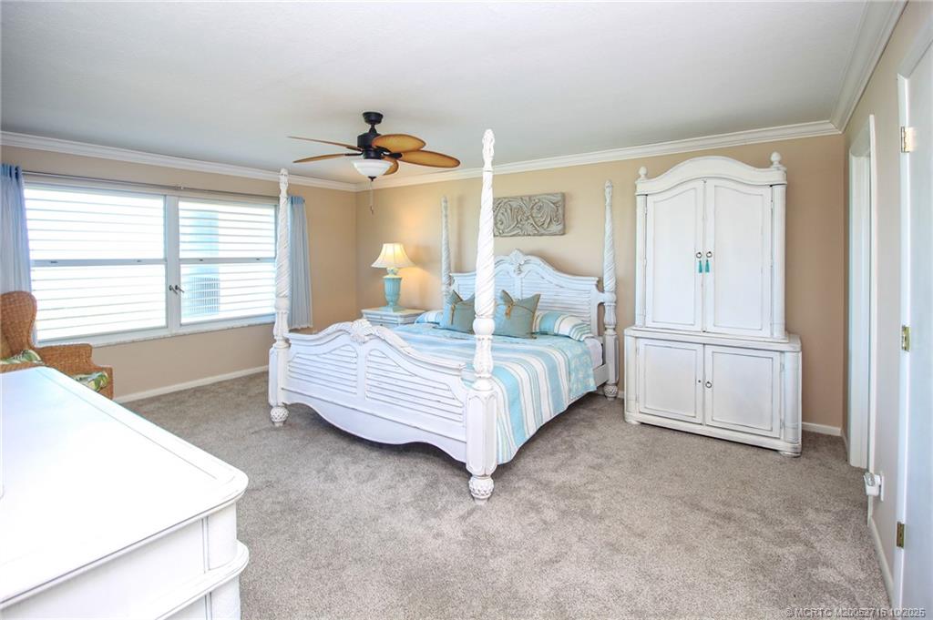 2571 Northeast Ocean Boulevard, Unit 10203 Stuart, FL 34996 - Photo 21 of 46 a bedroom with a bed and a cabinets