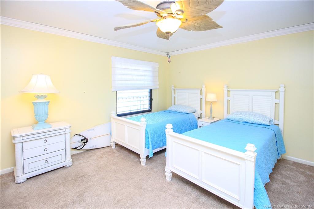 2571 Northeast Ocean Boulevard, Unit 10203 Stuart, FL 34996 - Photo 27 of 46 a bedroom with a bed and a chandelier