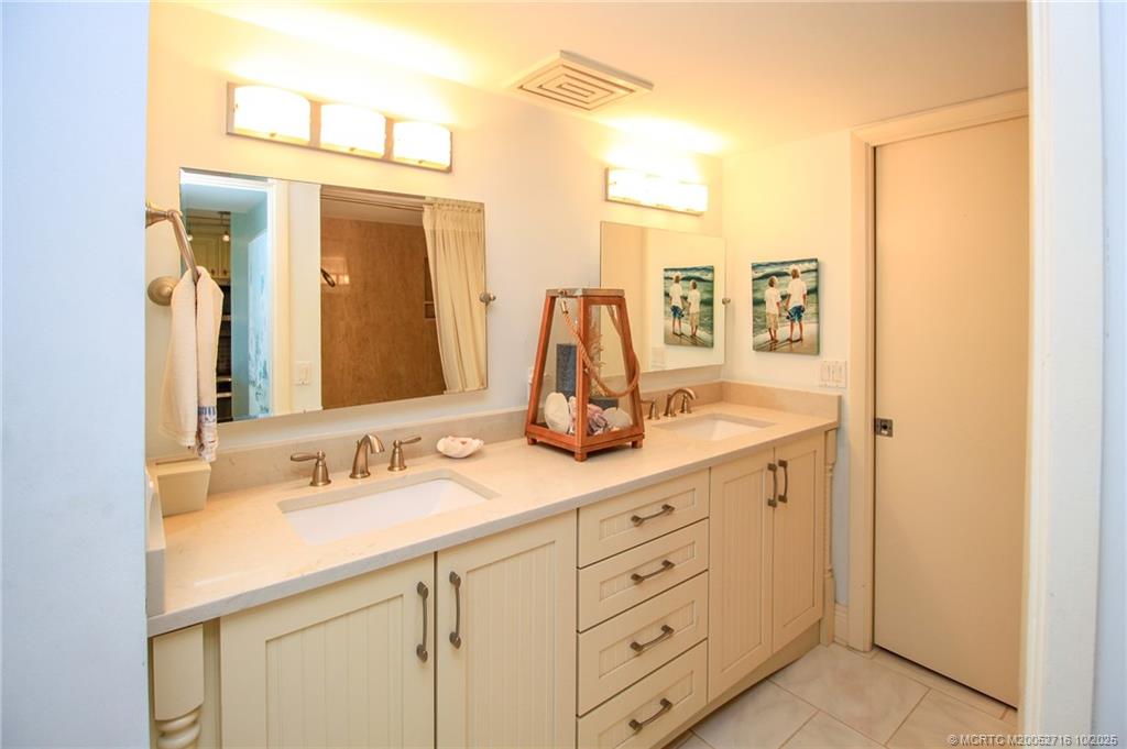 2571 Northeast Ocean Boulevard, Unit 10203 Stuart, FL 34996 - Photo 29 of 46 a bathroom with a double vanity sink mirror and