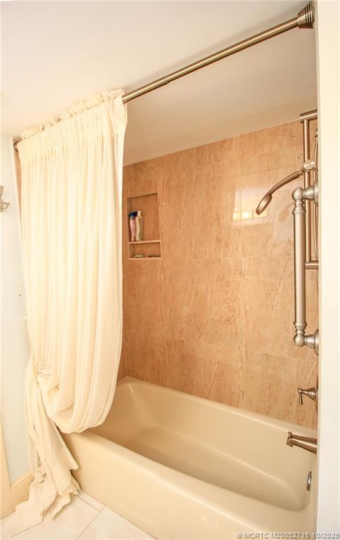 2571 Northeast Ocean Boulevard, Unit 10203 Stuart, FL 34996 - Photo 31 of 46 a bathroom with a shower and a tub