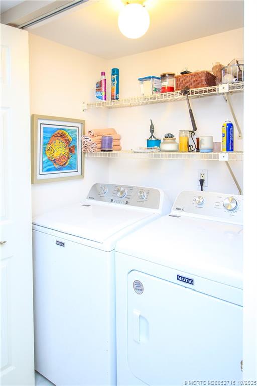 2571 Northeast Ocean Boulevard, Unit 10203 Stuart, FL 34996 - Photo 32 of 46 a utility room with a refrigerator a washer and dryer