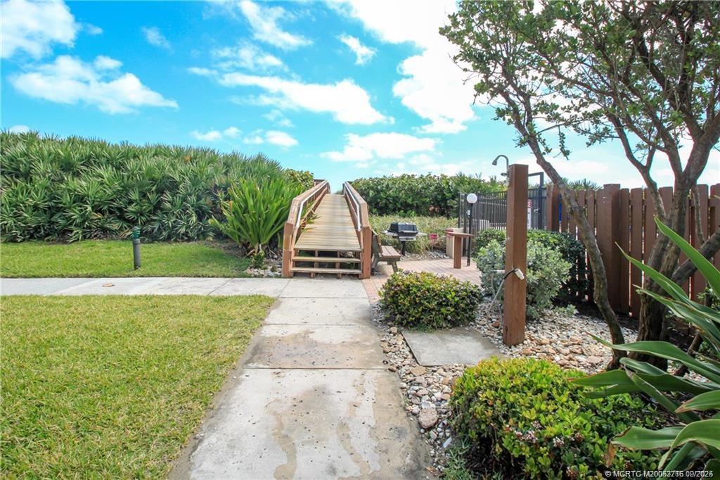 2571 Northeast Ocean Boulevard, Unit 10203 Stuart, FL 34996 - Photo 34 of 46 a view of a garden with a slide