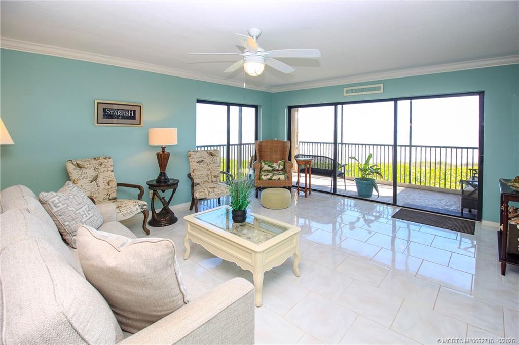 2571 Northeast Ocean Boulevard, Unit 10203 Stuart, FL 34996 - Photo 8 of 46 a living room with furniture and large windows