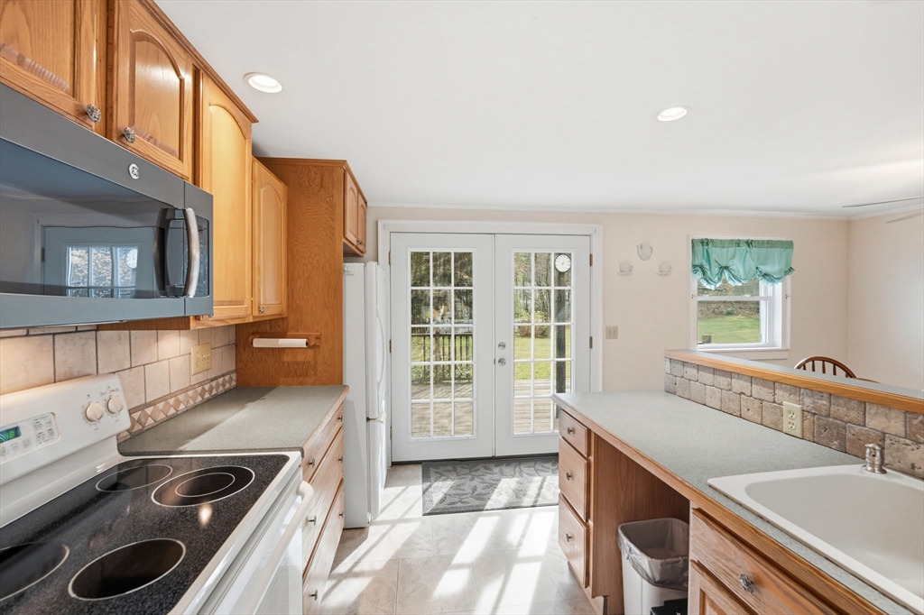 58 Colburn Road Charlton, MA 01507 - Photo 11 of 34 a view of a kitchen with a sink and windows