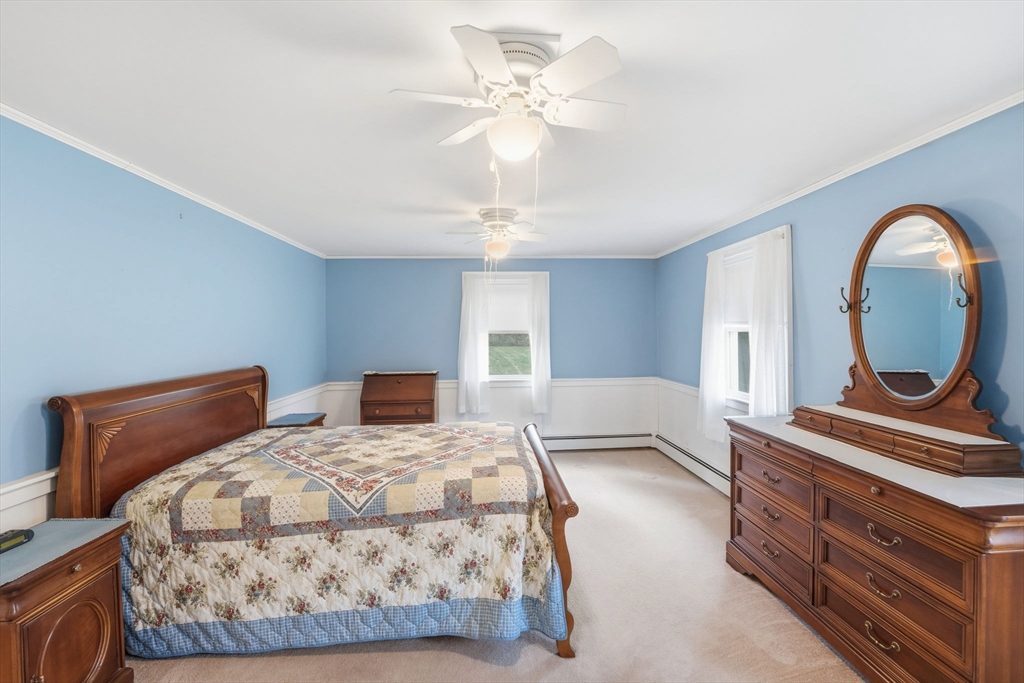 58 Colburn Road Charlton, MA 01507 - Photo 13 of 34 a bedroom with a large bed and a chandelier
