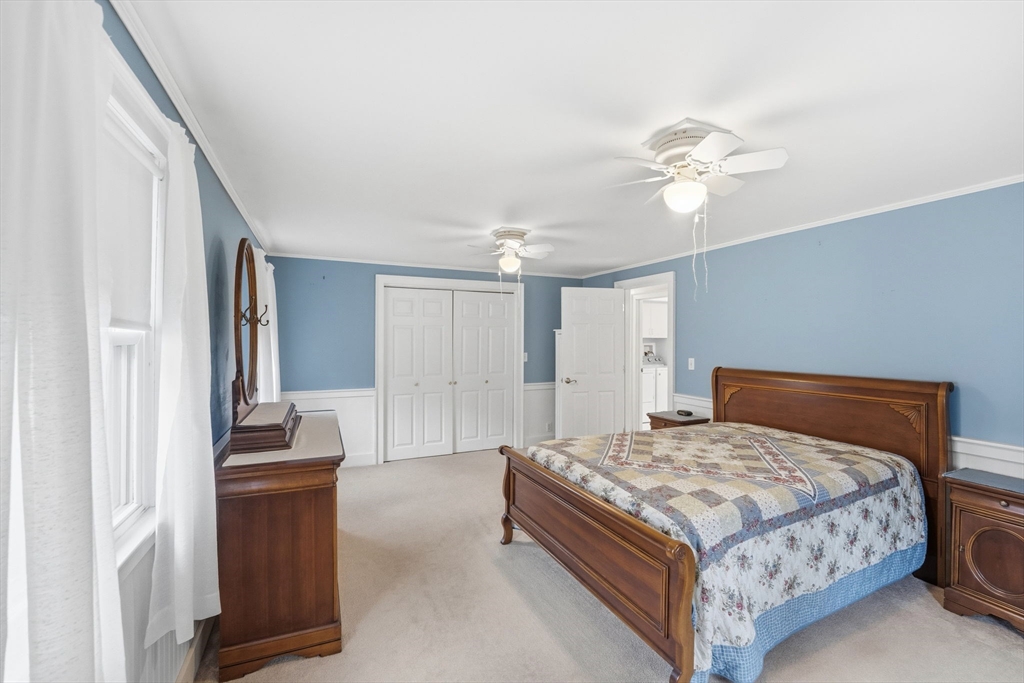 58 Colburn Road Charlton, MA 01507 - Photo 14 of 34 a bedroom with a large bed and a chandelier