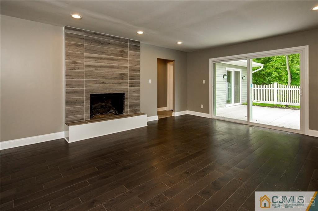 9 Edgewood Road Old Bridge, NJ 07747 - Photo 23 of 35 an empty room with wooden floor fireplace and windows