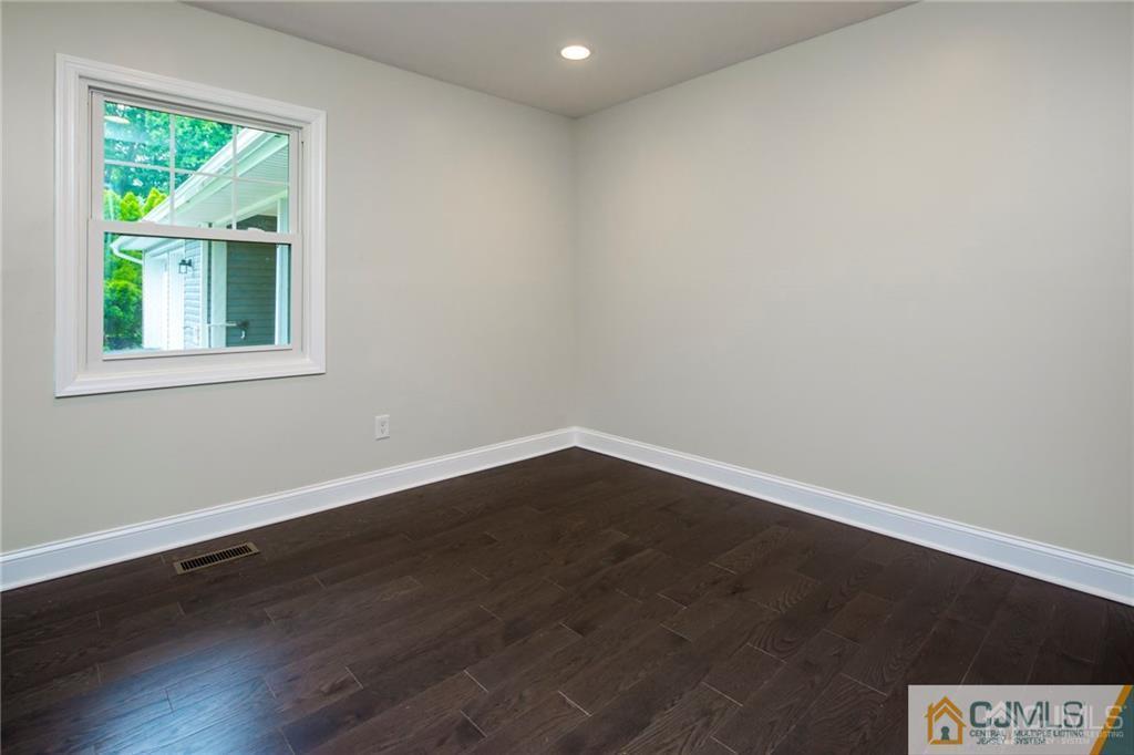 9 Edgewood Road Old Bridge, NJ 07747 - Photo 28 of 35 an empty room with wooden floor and a window