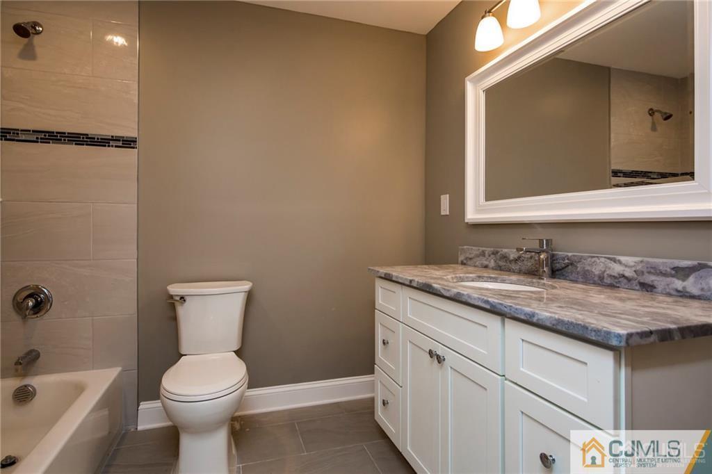9 Edgewood Road Old Bridge, NJ 07747 - Photo 32 of 35 a bathroom with a granite countertop toilet sink and mirror