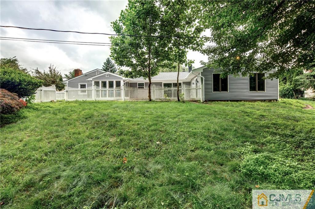 9 Edgewood Road Old Bridge, NJ 07747 - Photo 6 of 35 a front view of a house with a yard and trees