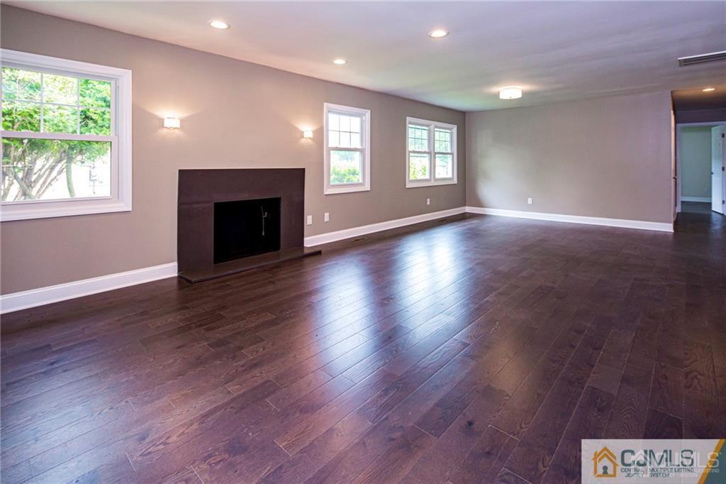 9 Edgewood Road Old Bridge, NJ 07747 - Photo 8 of 35 an empty room with wooden floor fireplace and windows