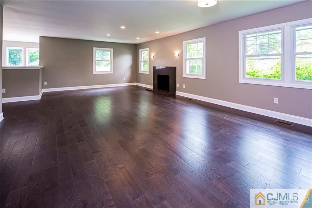 9 Edgewood Road Old Bridge, NJ 07747 - Photo 9 of 35 an empty room with wooden floor and windows