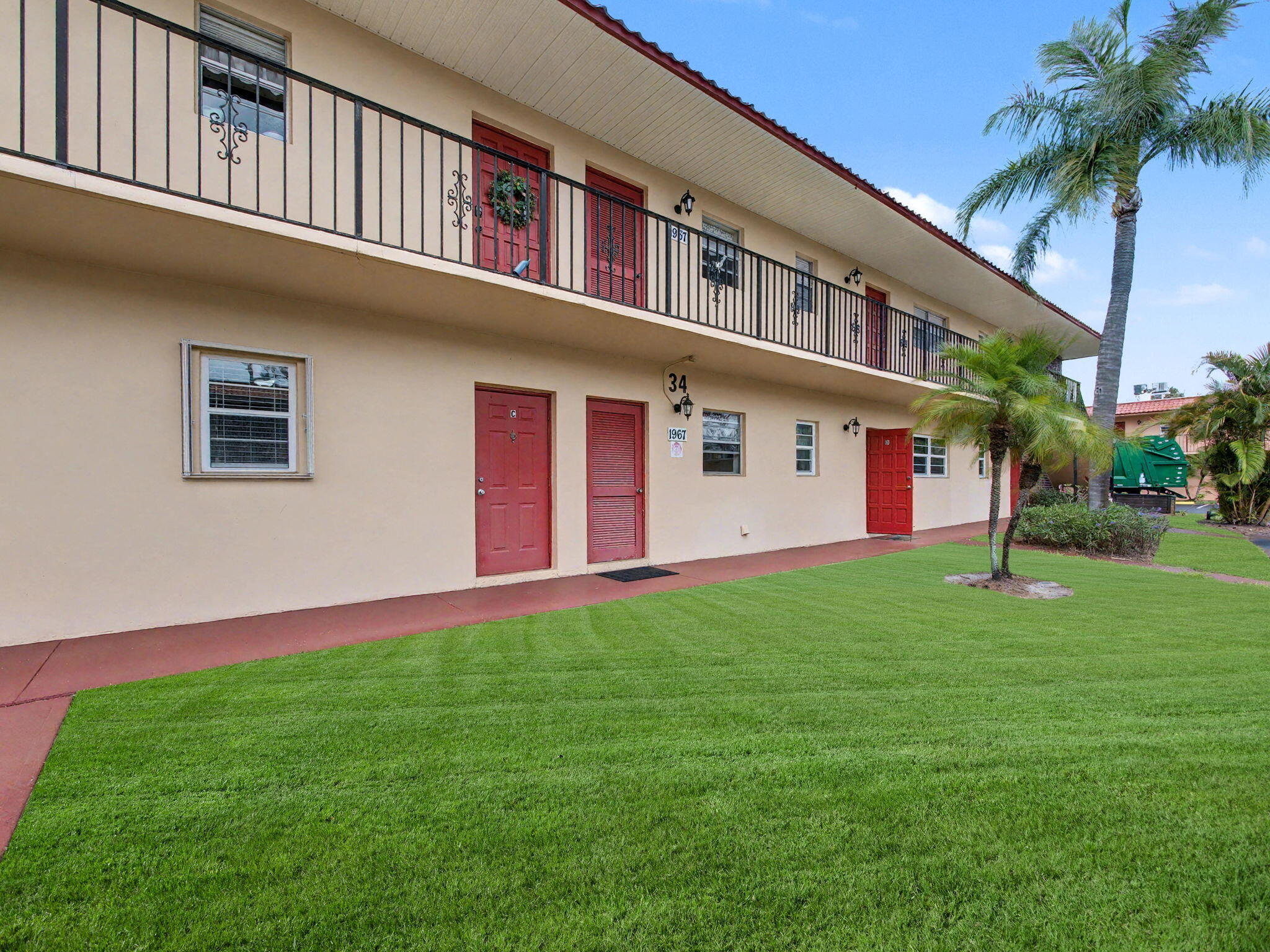1967 Southwest Palm City Road, Unit 34C Stuart, FL 34994 - Photo 25 of 25 a front view of a house with a yard and garage