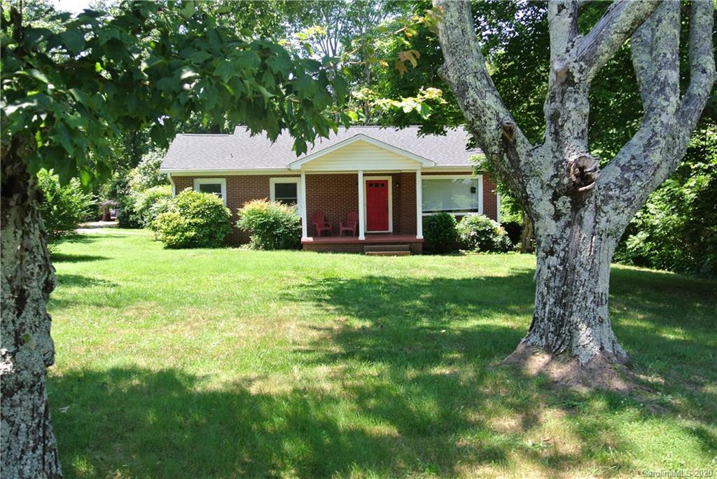 553 Chimney Rock Road Rutherfordton, NC 28139 - Photo 2 of 12 a front view of a house with yard and green space