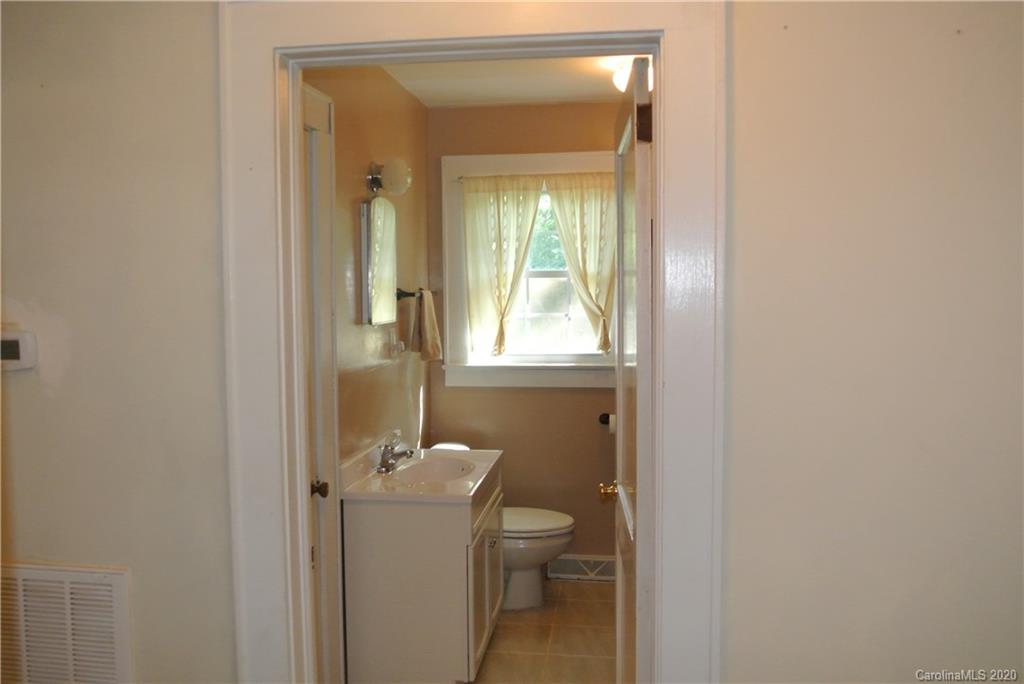 553 Chimney Rock Road Rutherfordton, NC 28139 - Photo 12 of 12 a bathroom with a granite countertop toilet and a sink