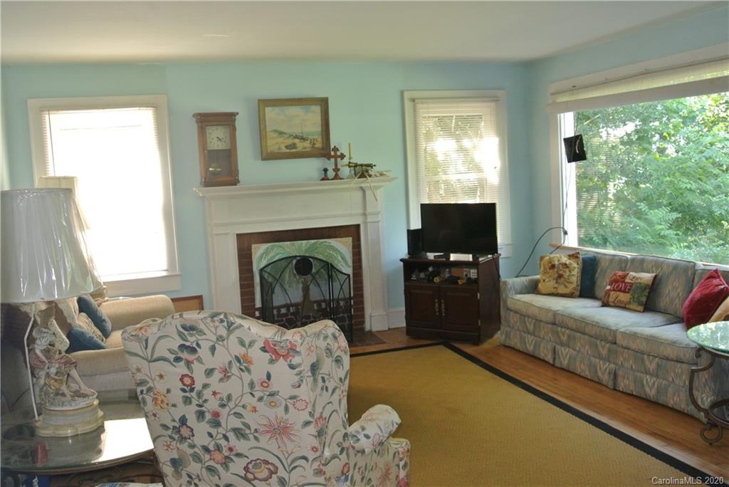 553 Chimney Rock Road Rutherfordton, NC 28139 - Photo 6 of 12 a living room with furniture a flat screen tv and a fireplace