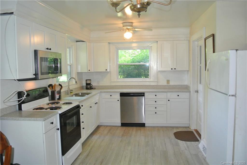 553 Chimney Rock Road Rutherfordton, NC 28139 - Photo 8 of 12 a kitchen with a sink a stove a refrigerator and a window
