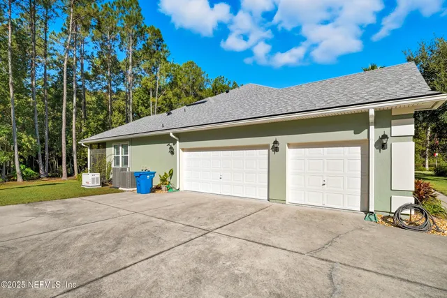 a view of a house with a yard and garage