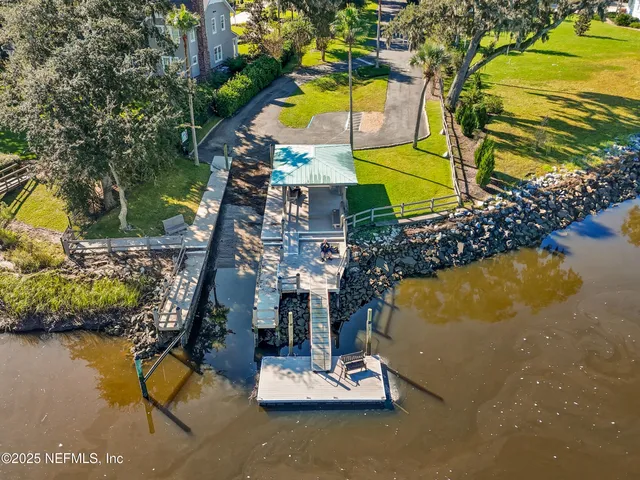 an aerial view of a house with a swimming pool yard and outdoor seating