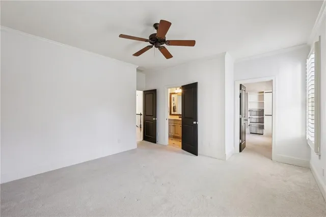 a view of empty room with ceiling fan