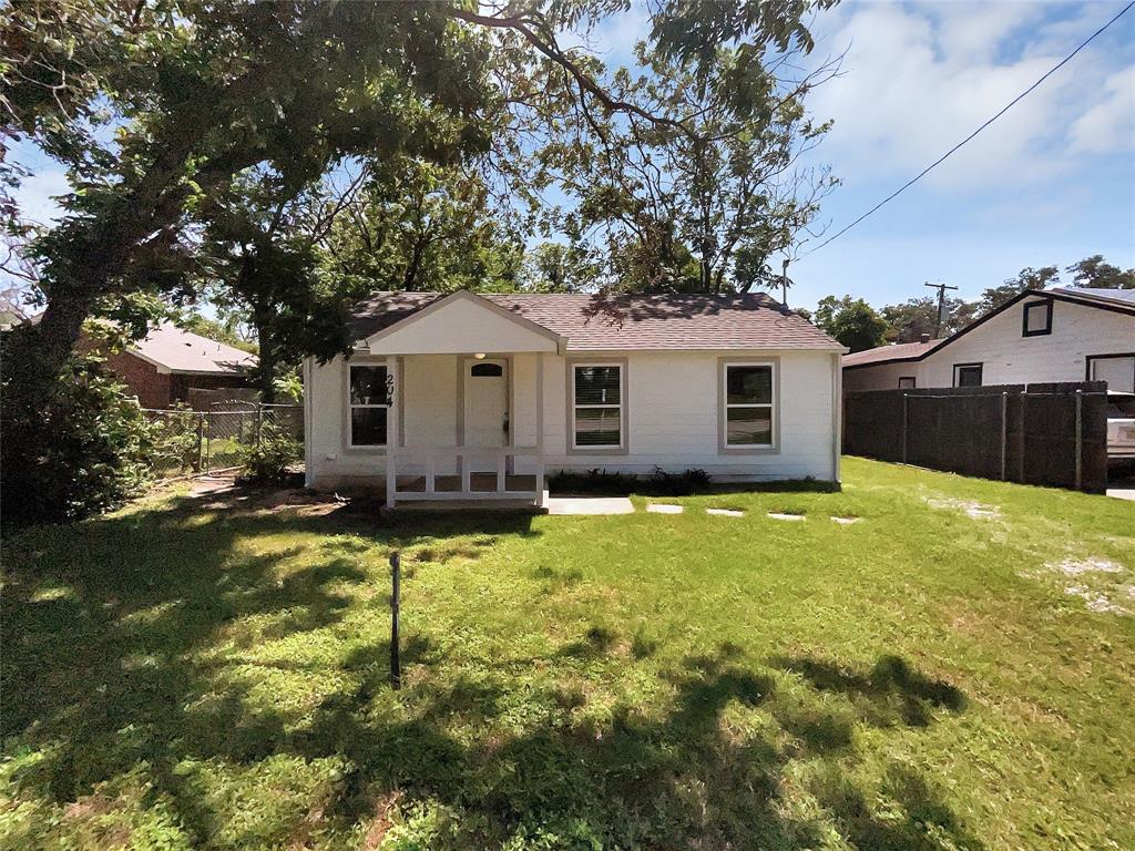 a front view of a house with yard and green space
