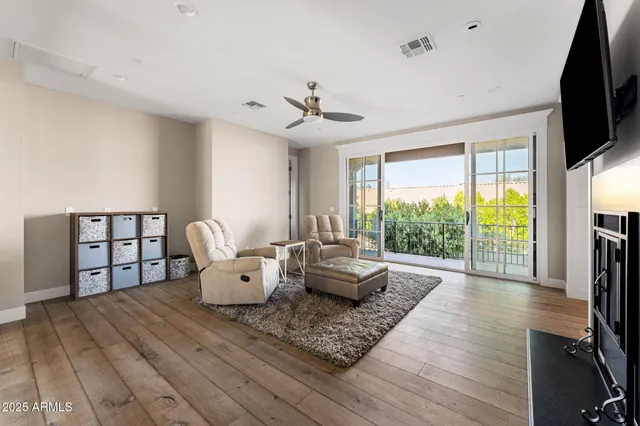 a living room with furniture fireplace and flat screen tv