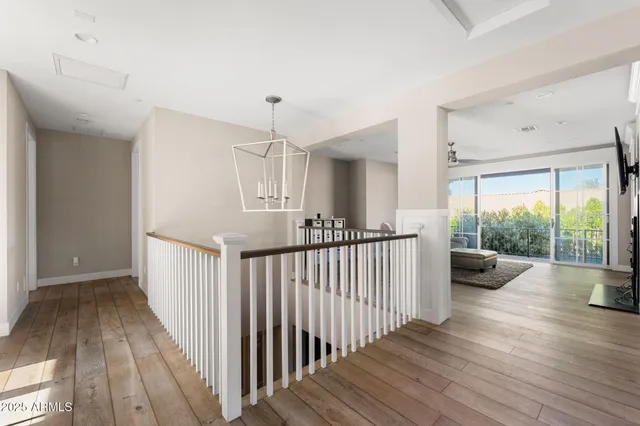 a view of a hallway view with wooden floor and dining room