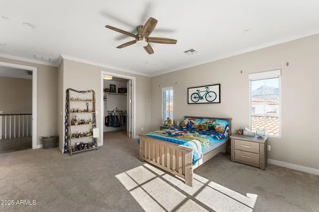 a bedroom with bed and a chandelier