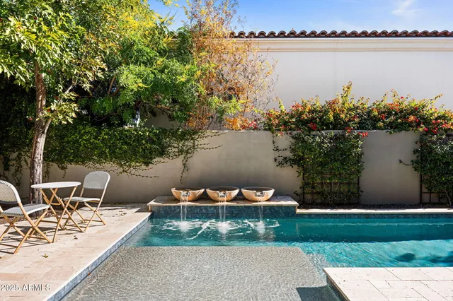 a view of a lake with chairs